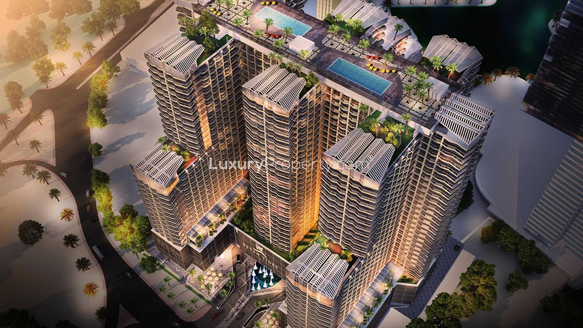 Aerial view of Se7en City JLT apartment complex with rooftop pools in Jumeirah Lake Towers