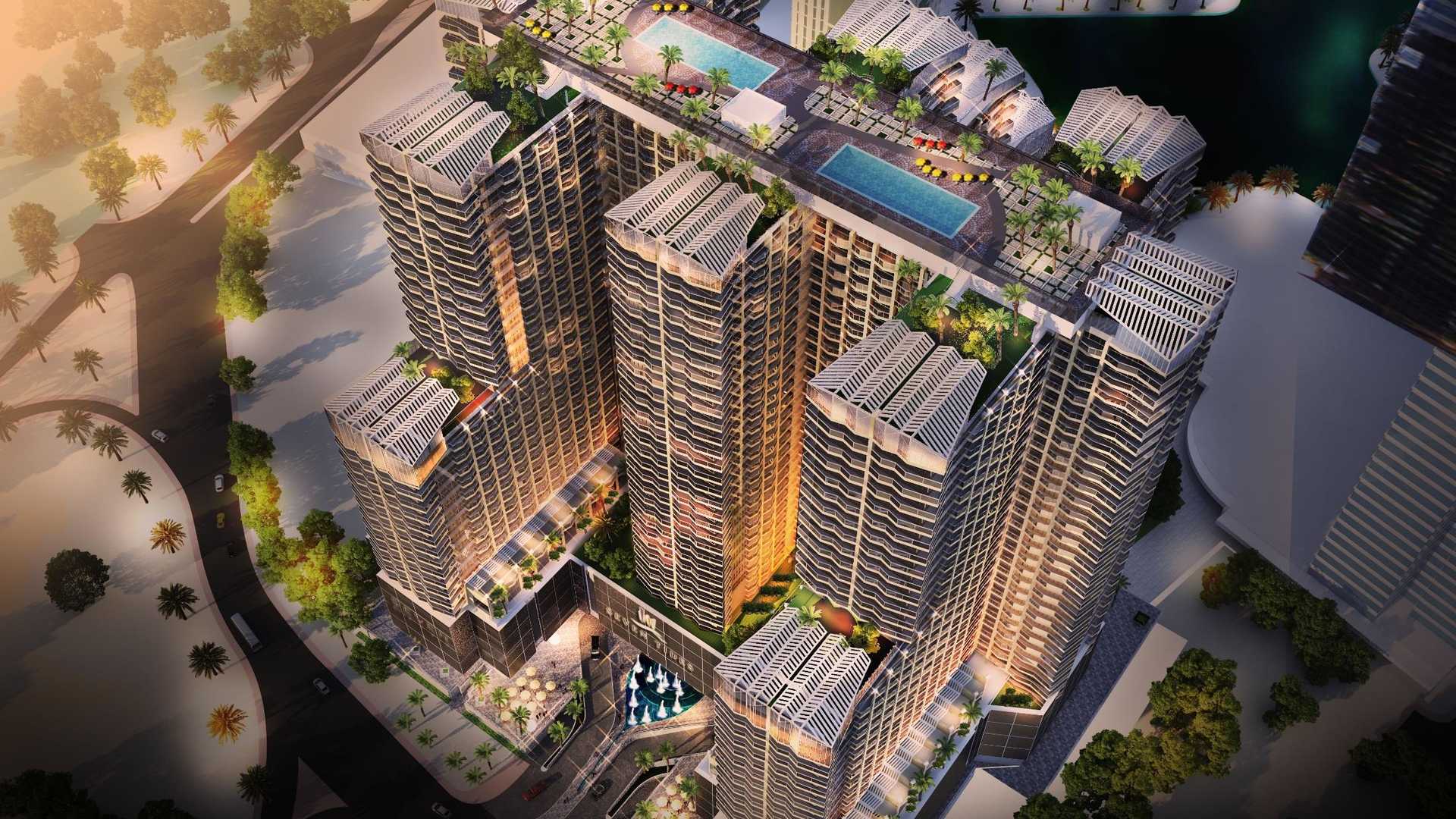 Aerial view of Se7en City JLT apartment complex with rooftop pools in Jumeirah Lake Towers