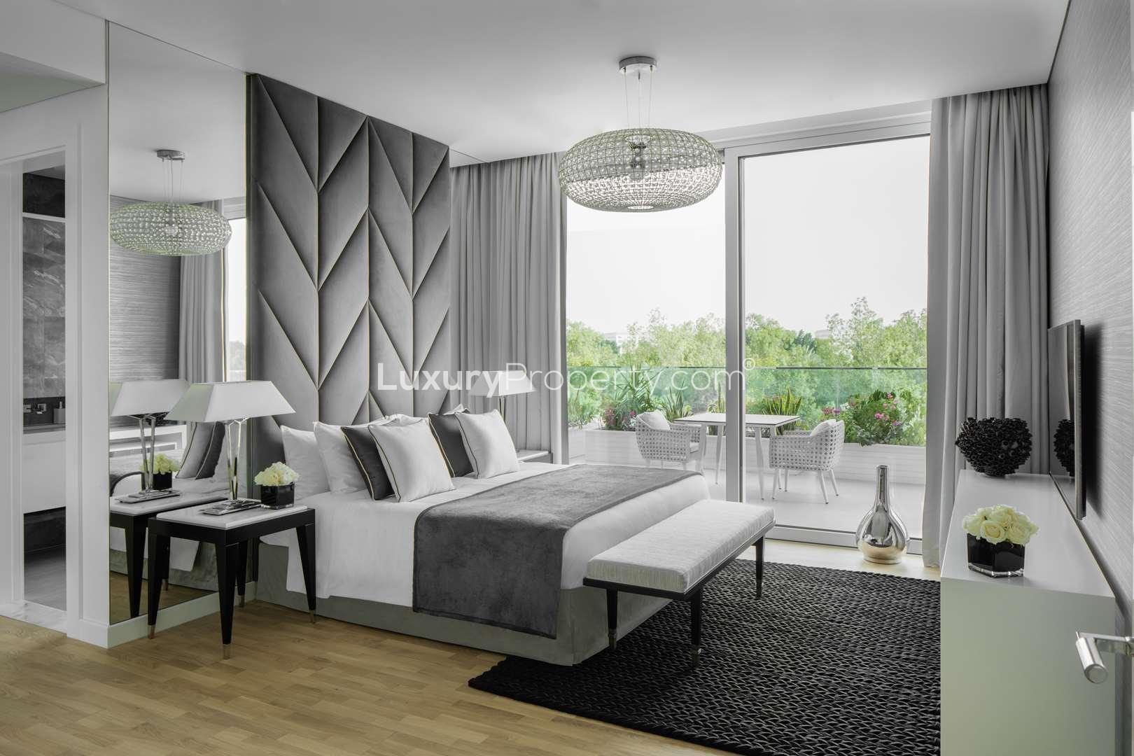 Seventh Heaven Al Barari apartment exterior with lush greenery and outdoor seating area