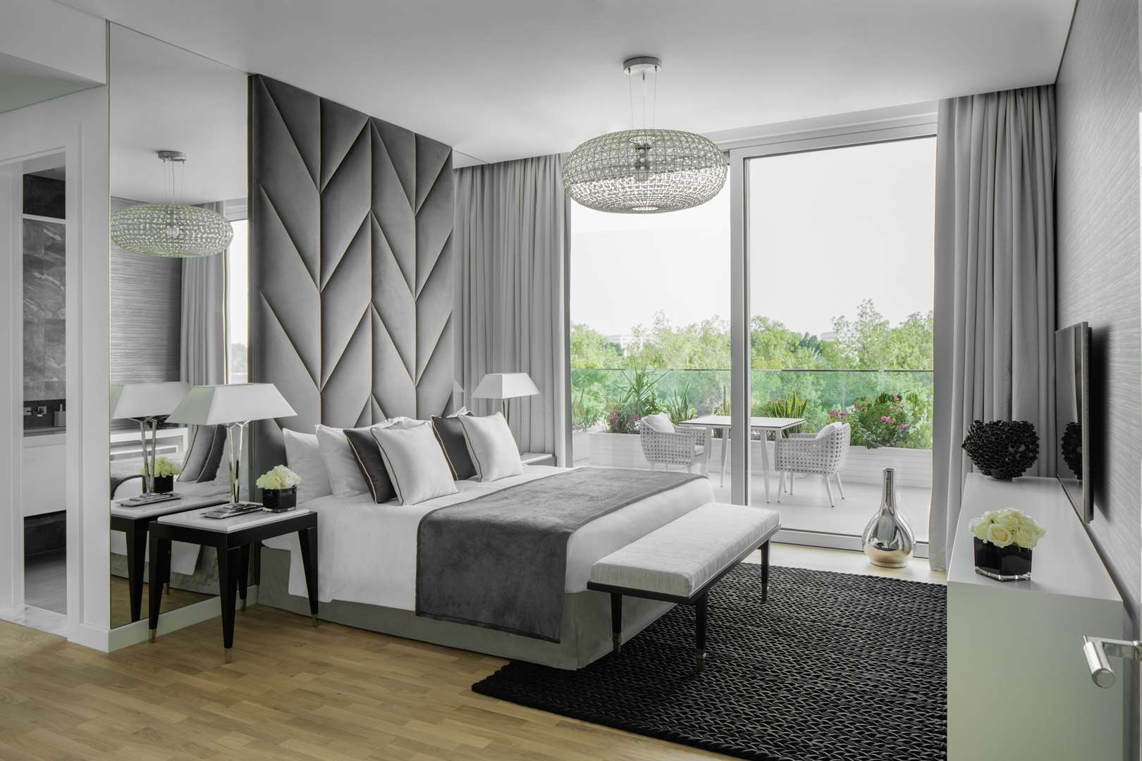 Seventh Heaven Al Barari apartment exterior with lush greenery and outdoor seating area