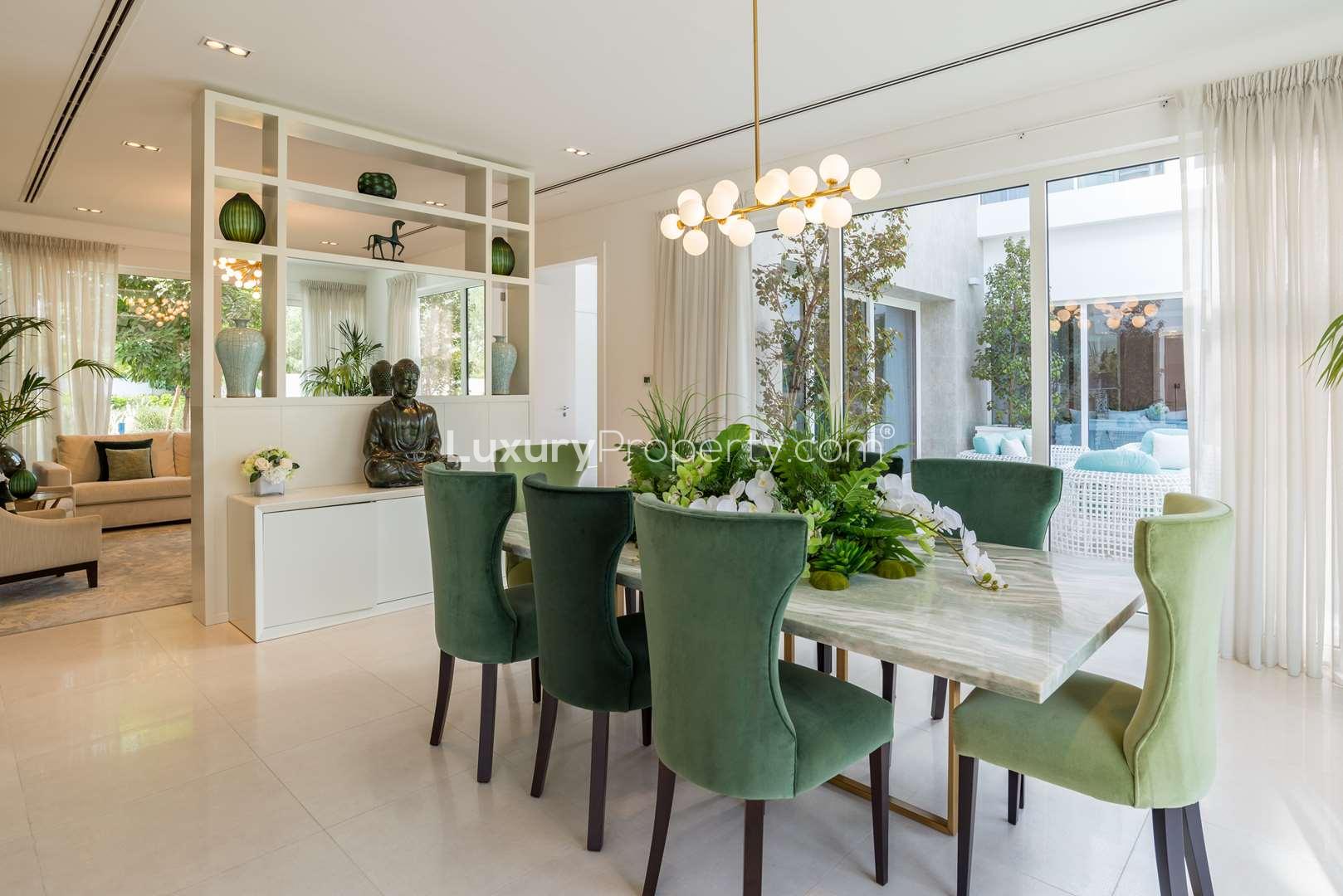 Modern kitchen interior in The Nest villa, Al Barari, featuring sleek white cabinetry and island