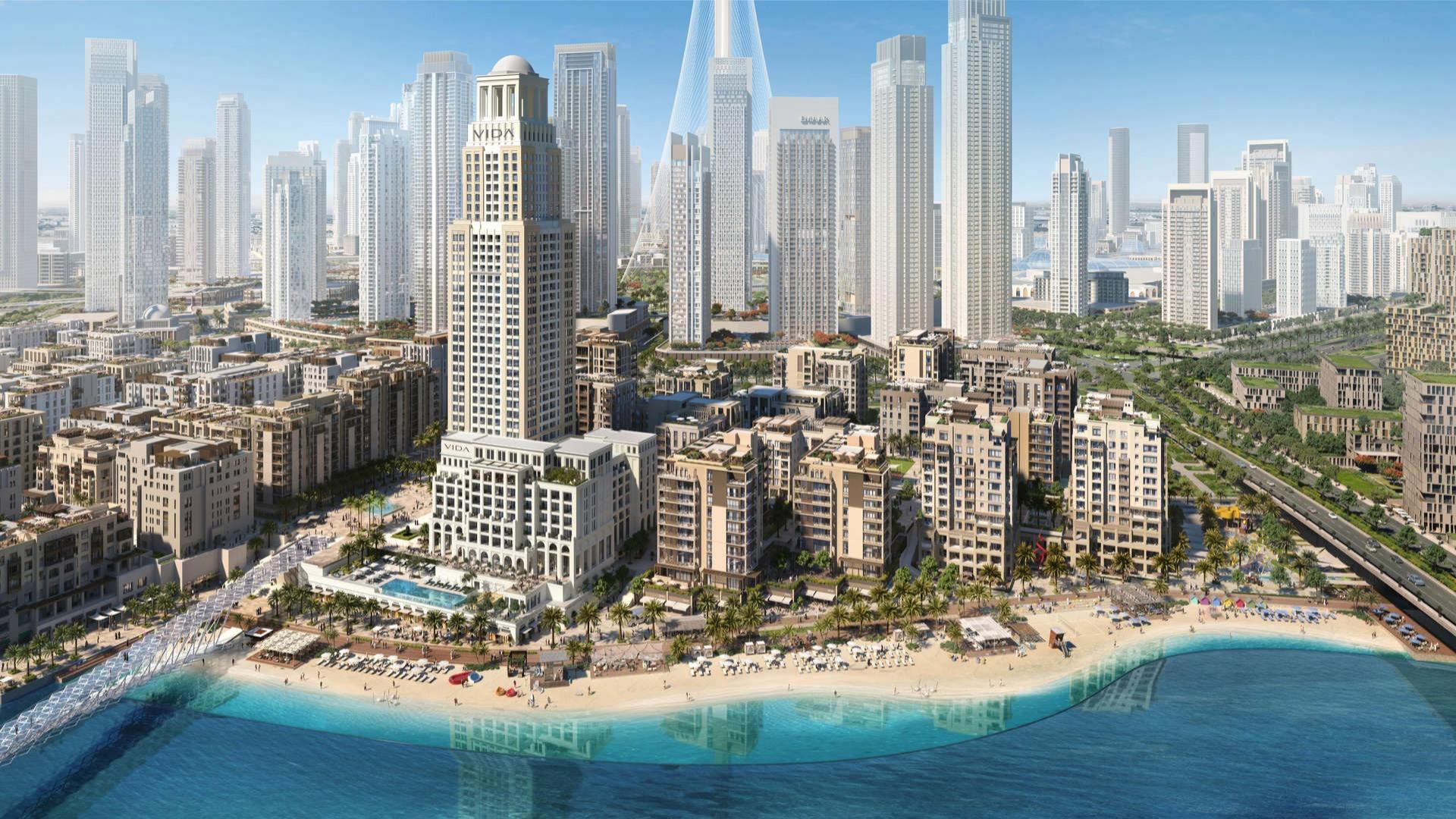 "Stunning Vida Residences Creek Beach apartment exterior at Dubai Creek Harbour, ideal investment opportunity.",Aerial view of Vida Residences Creek Beach in Dubai Creek Harbour, featuring beachfront apartments