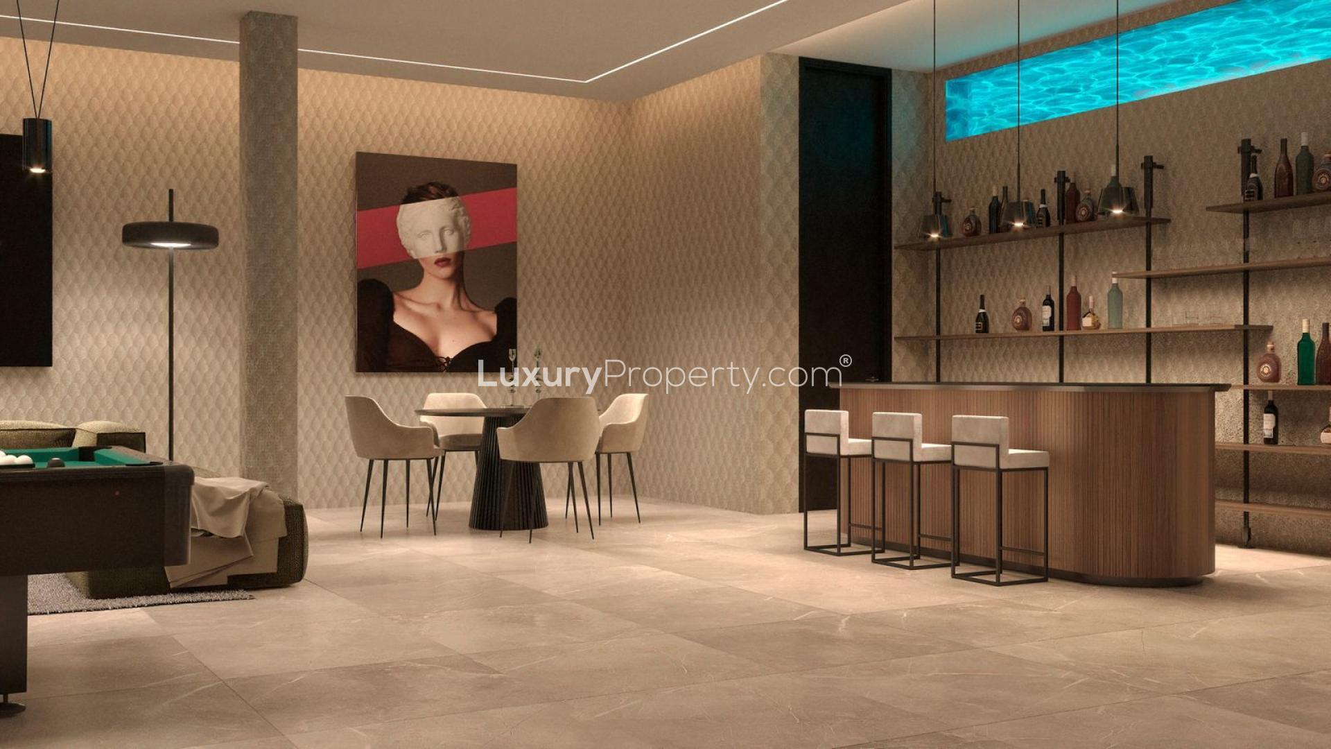 Modern kitchen with sea views, featuring sleek wood cabinetry and marble countertops in Málaga villa