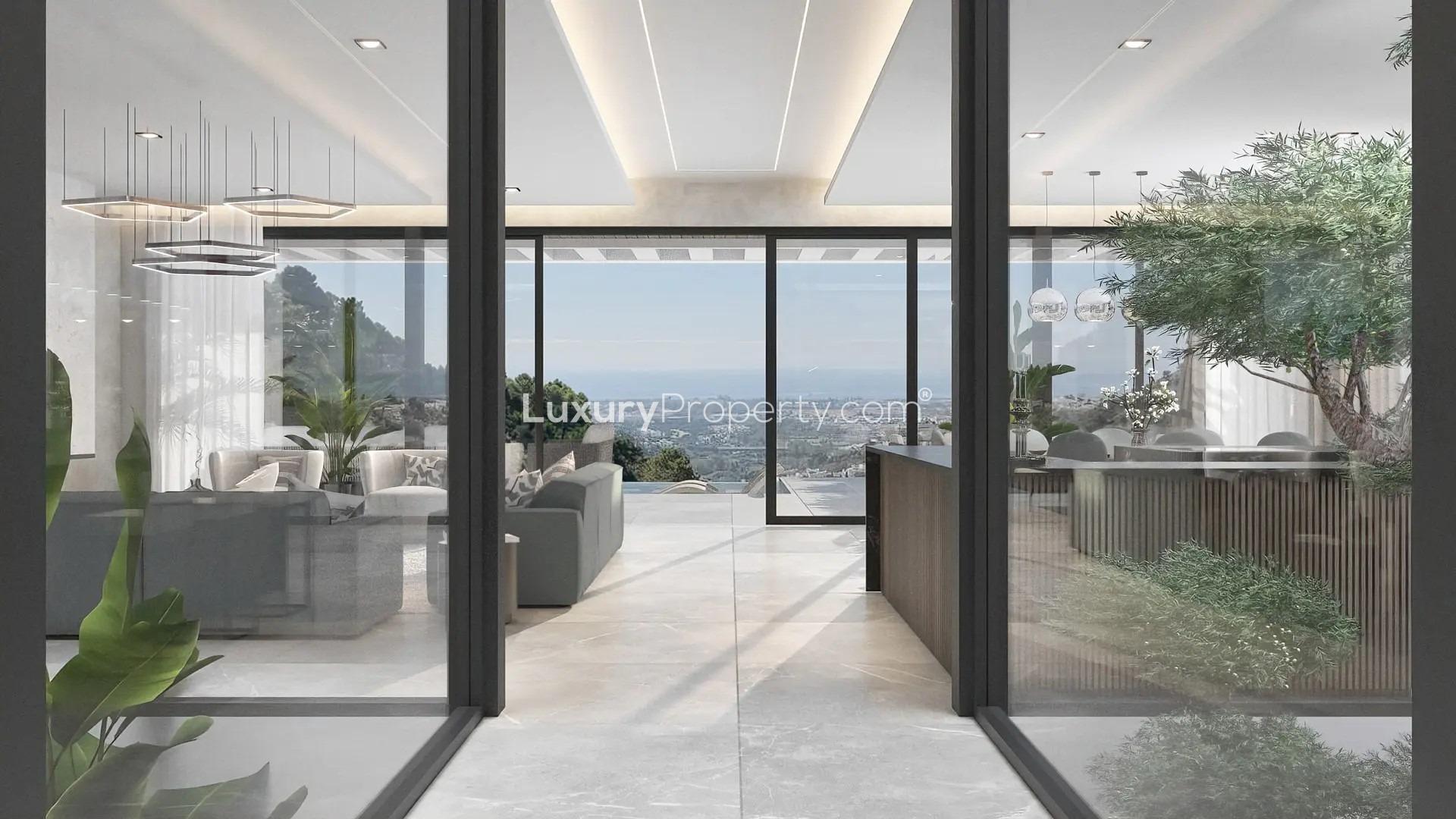 Front view of modern 6-bed villa in Benahavís with landscaped entrance and large windows