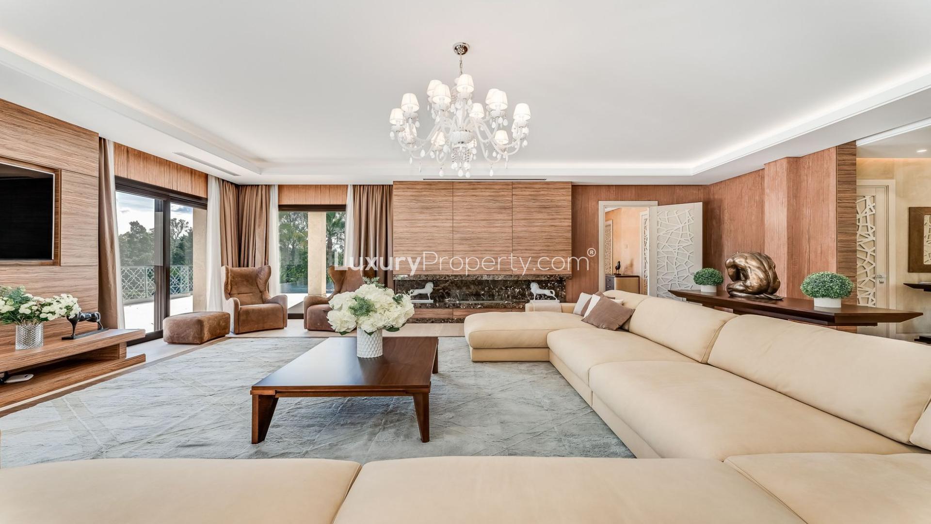 "Scenic view from 5-bedroom villa in Nueva Andalucía, Marbella, overlooking lush greenery.",Luxurious living room in 5-bedroom villa, Nueva Andalucía, Marbella, featuring elegant decor