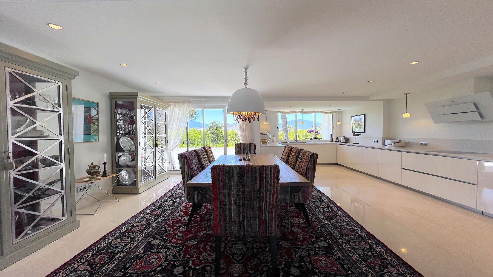 Spacious living room in Puerto Banús penthouse for sale, featuring modern decor and wooden floors