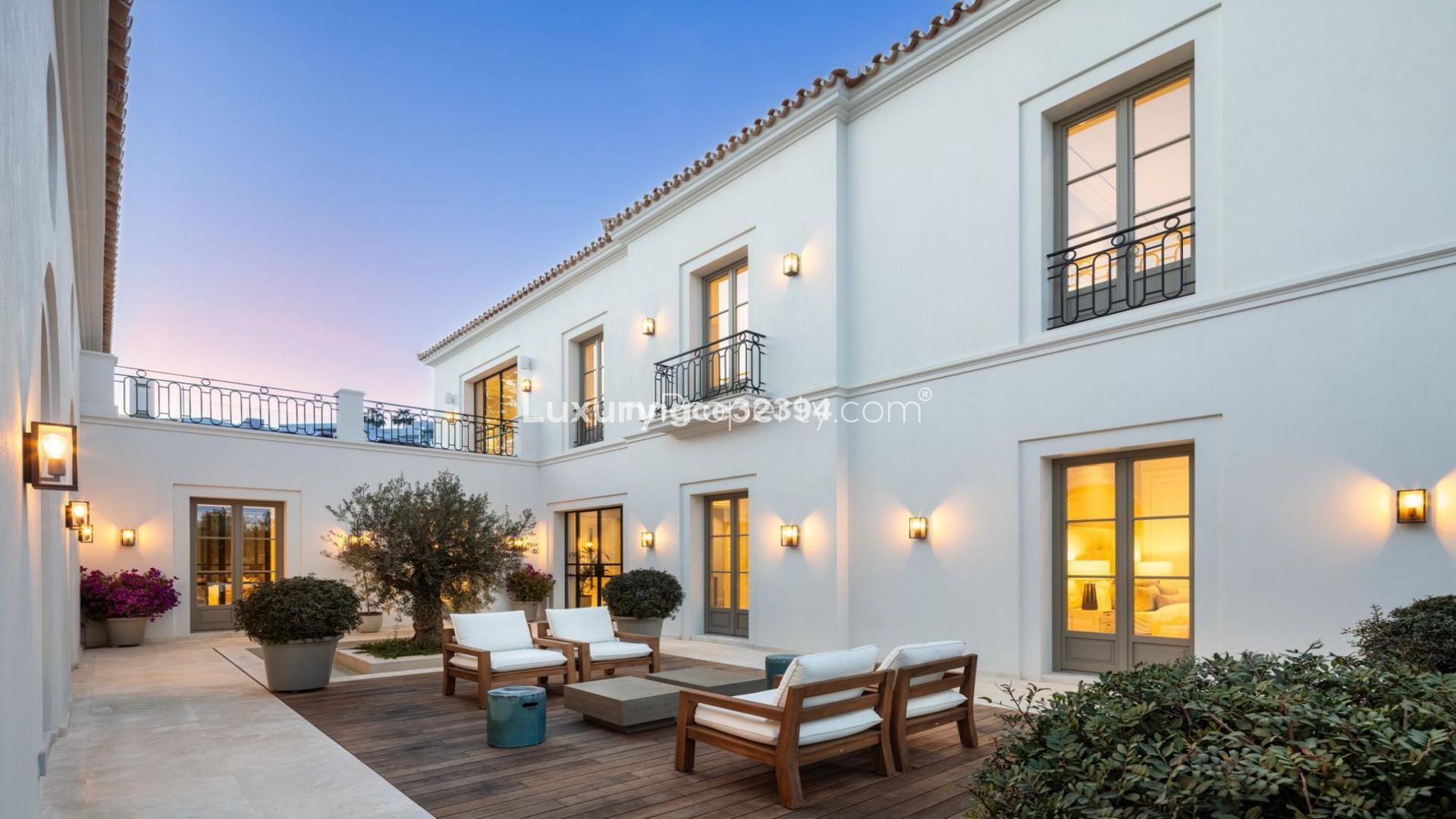 Outdoor dining area and pool at luxury 6-bedroom villa in Marbella’s Golf Valley