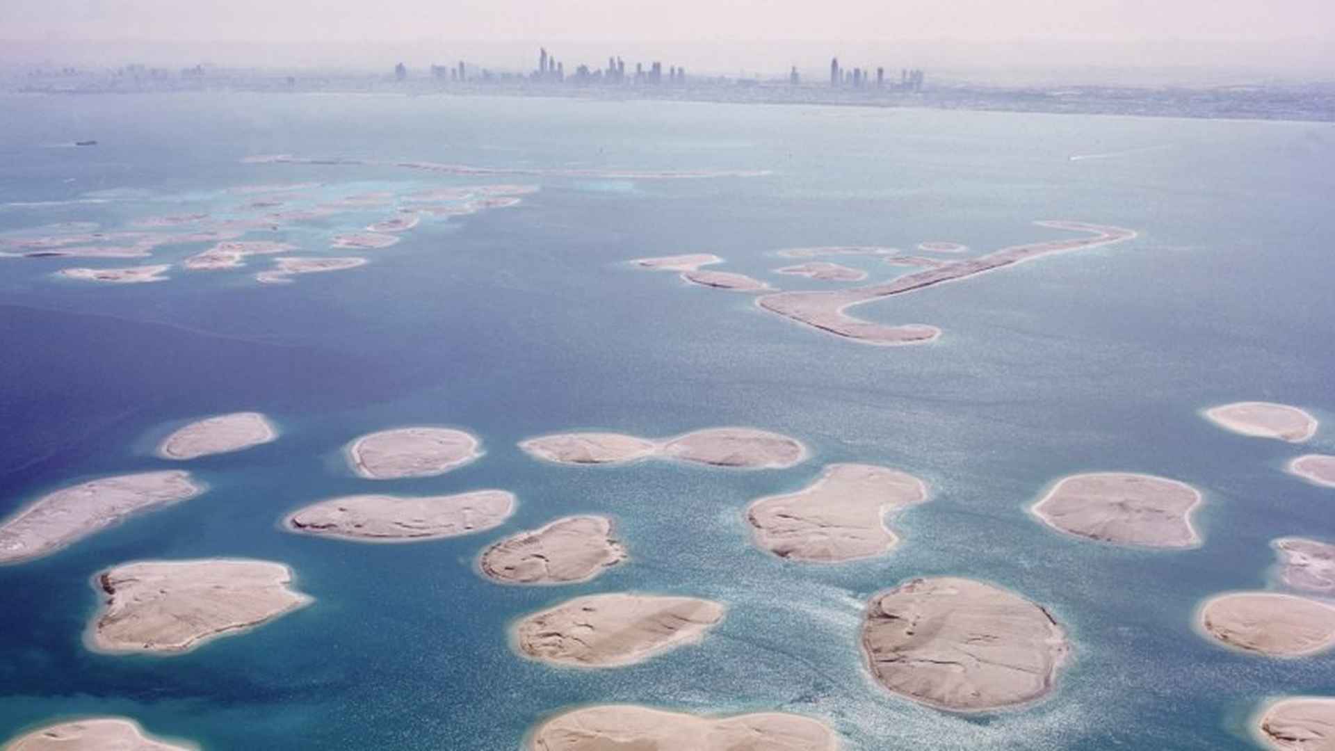 Aerial view of Colombia Island, The World Islands, Dubai, surrounded by turquoise sea