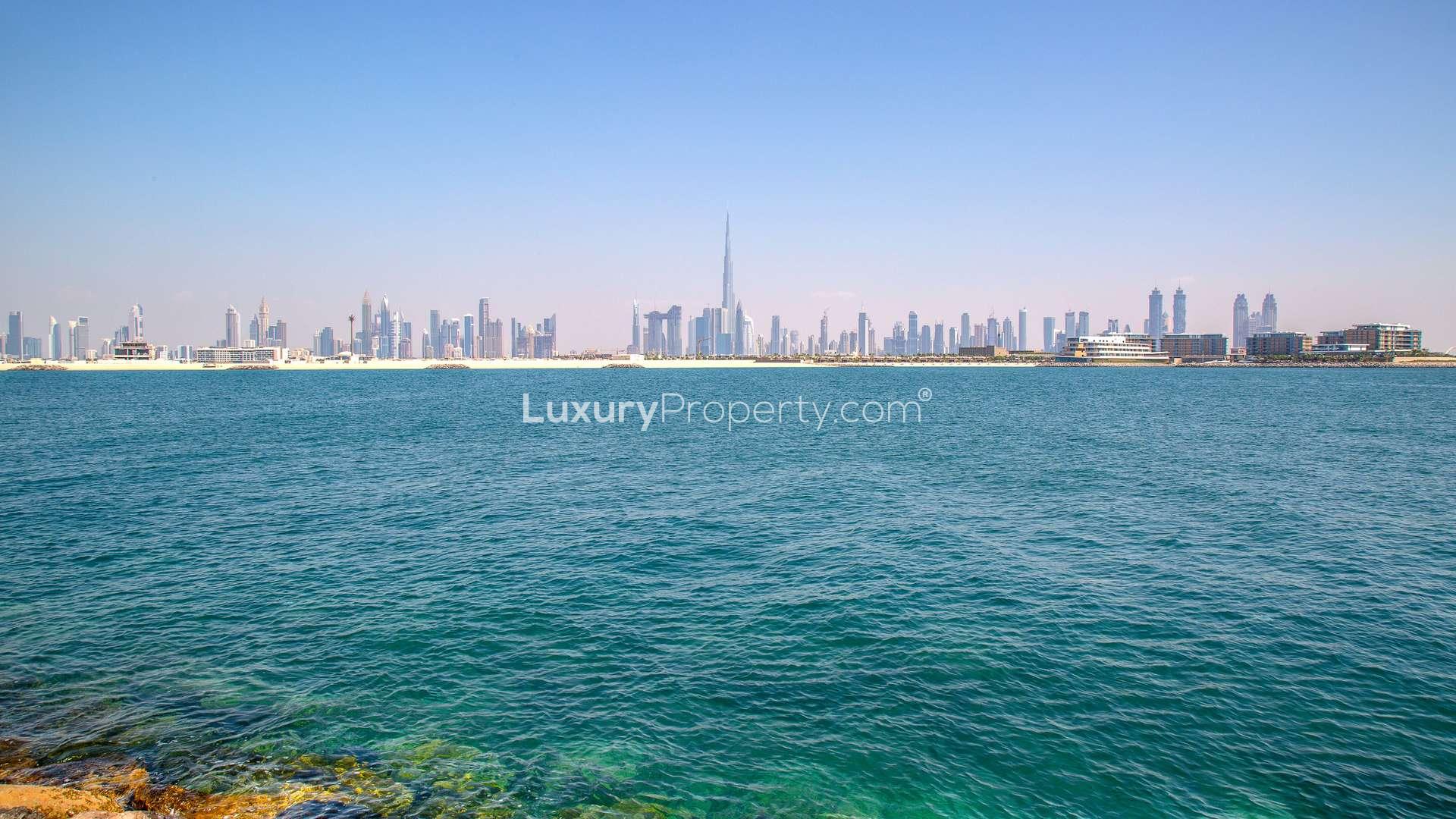 Exclusive beachfront residential plot view on Jumeirah Bay Island with city skyline backdrop