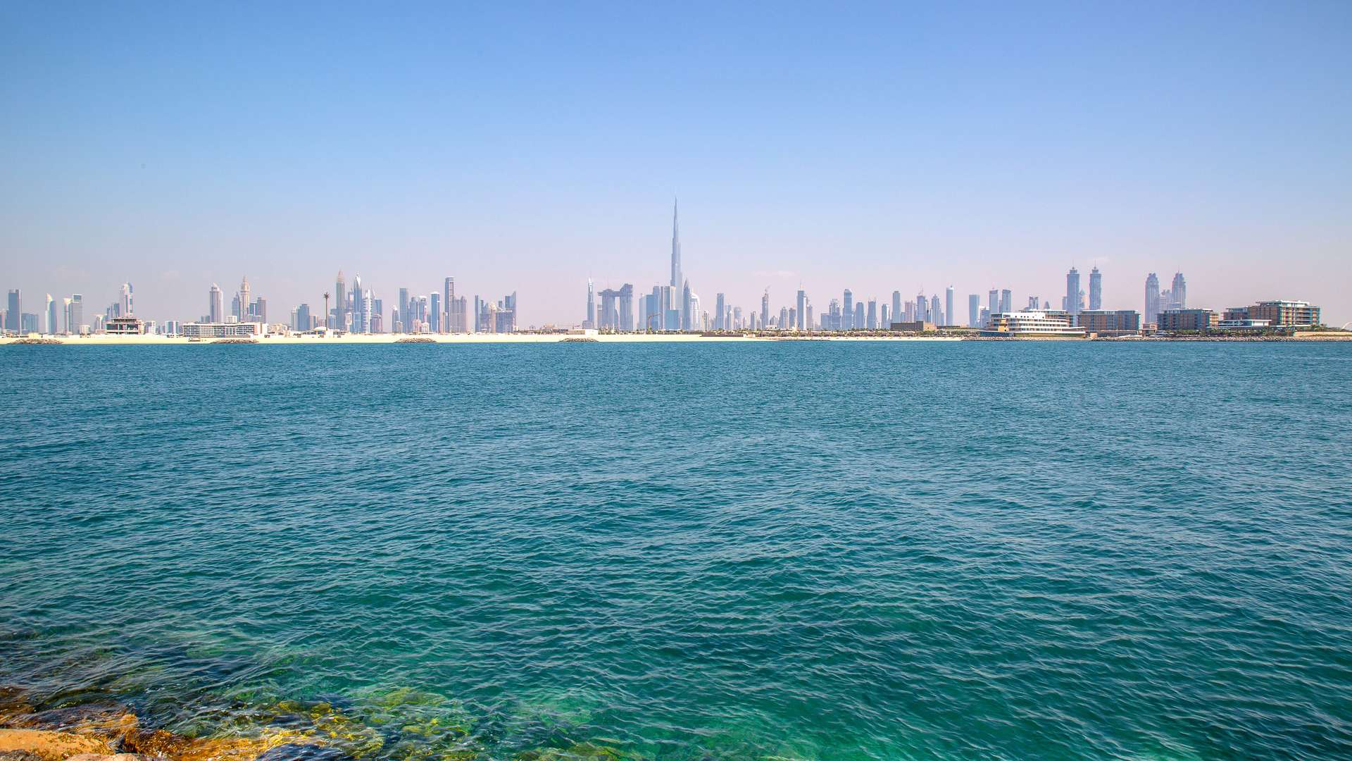Exclusive beachfront residential plot view on Jumeirah Bay Island with city skyline backdrop
