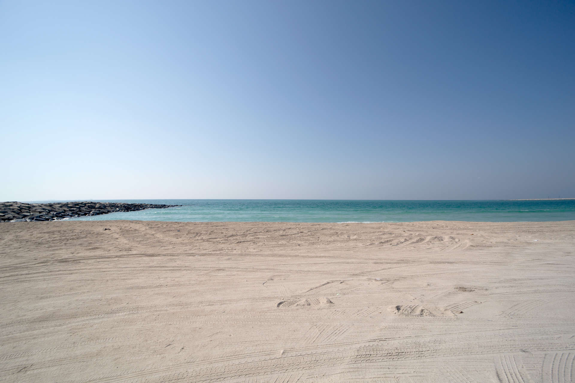 Dubai skyline view from Jumeirah Bay Island, showcasing iconic architecture and serene waters