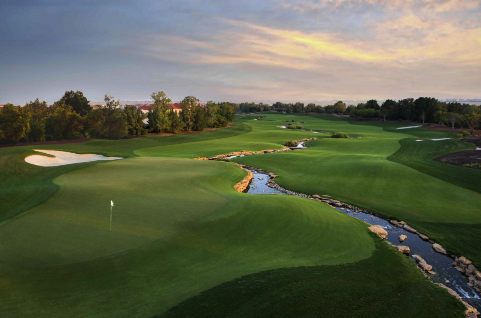 Aerial view of Jumeirah Golf Estates residential land plot for sale, lush greens and water features