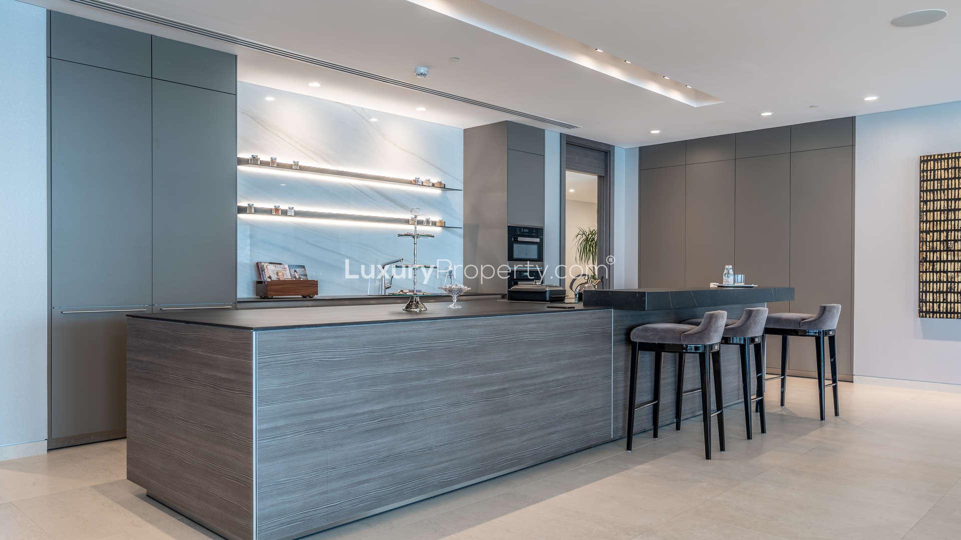 Modern kitchen in W Residences penthouse, Palm Jumeirah, with sleek design and bar stools