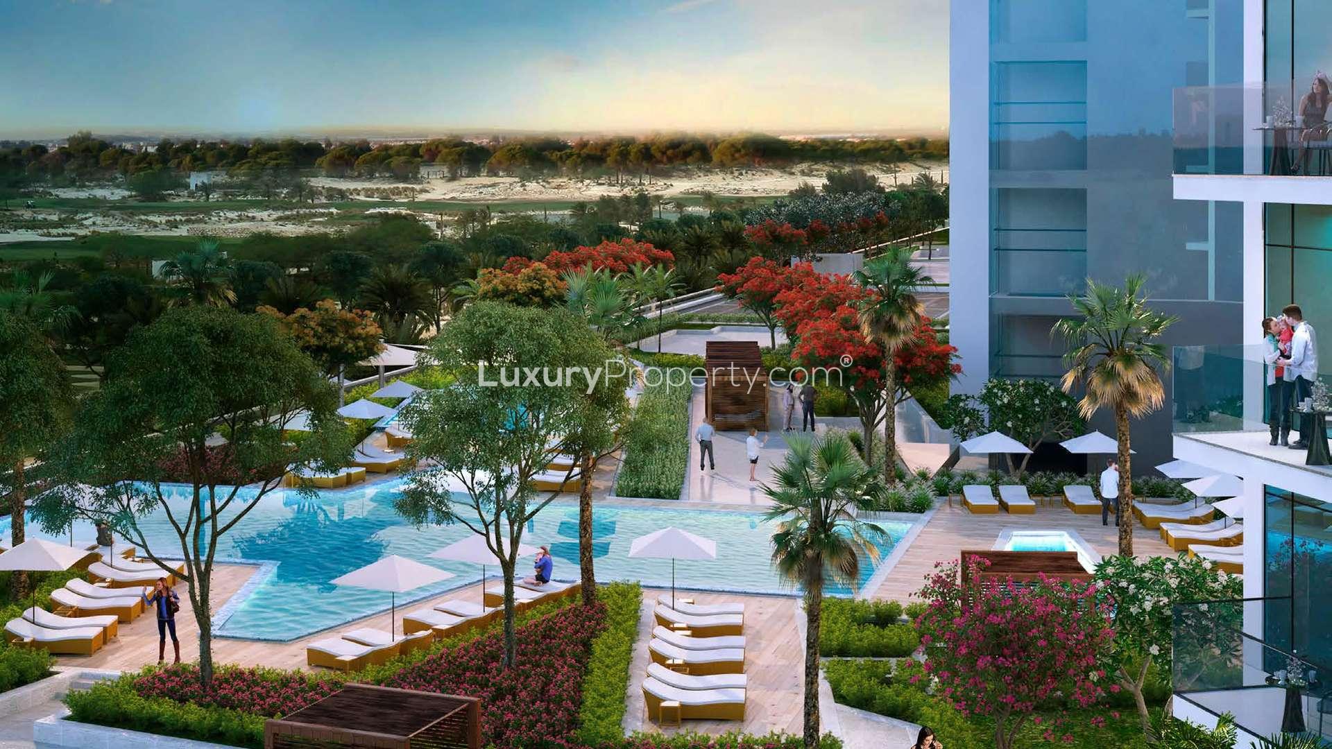 Couple enjoying balcony view at Radisson Dubai DAMAC Hills apartment in Dubailand