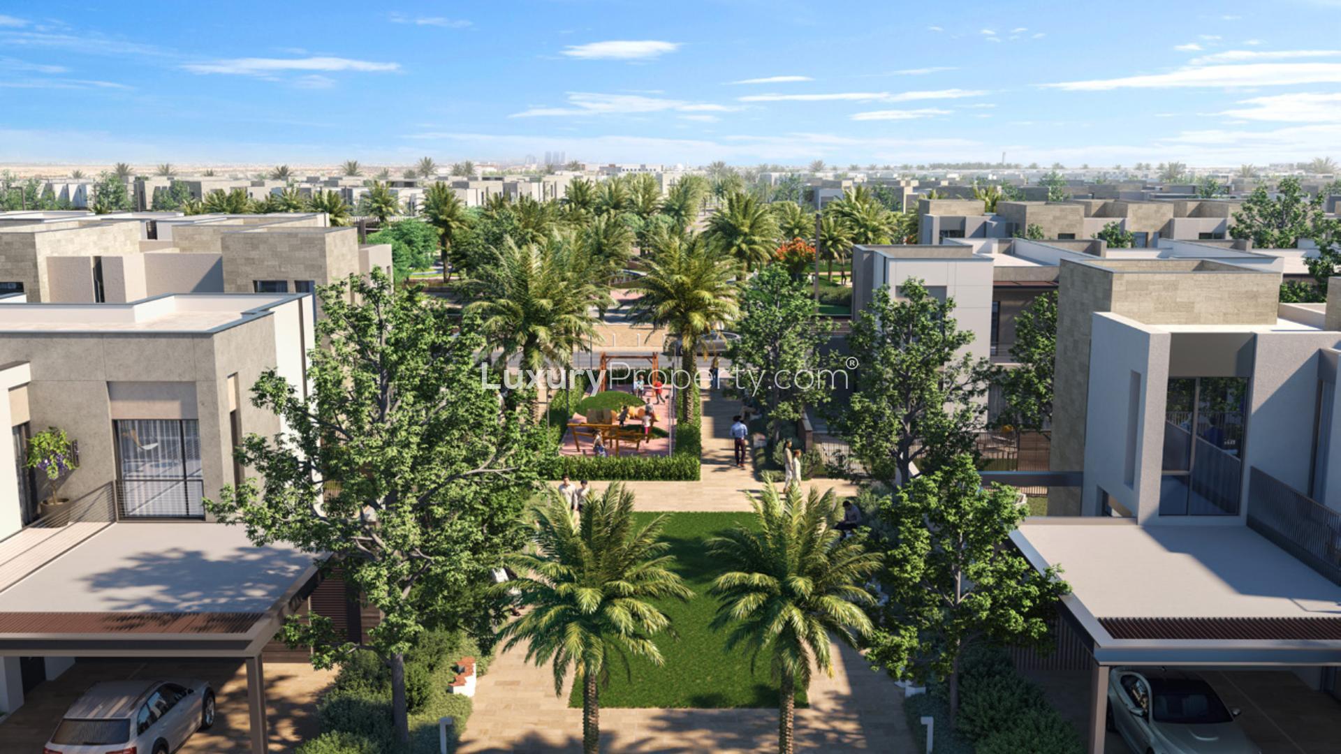 Modern townhouse exterior in Raya, Arabian Ranches III, surrounded by lush greenery and pathways