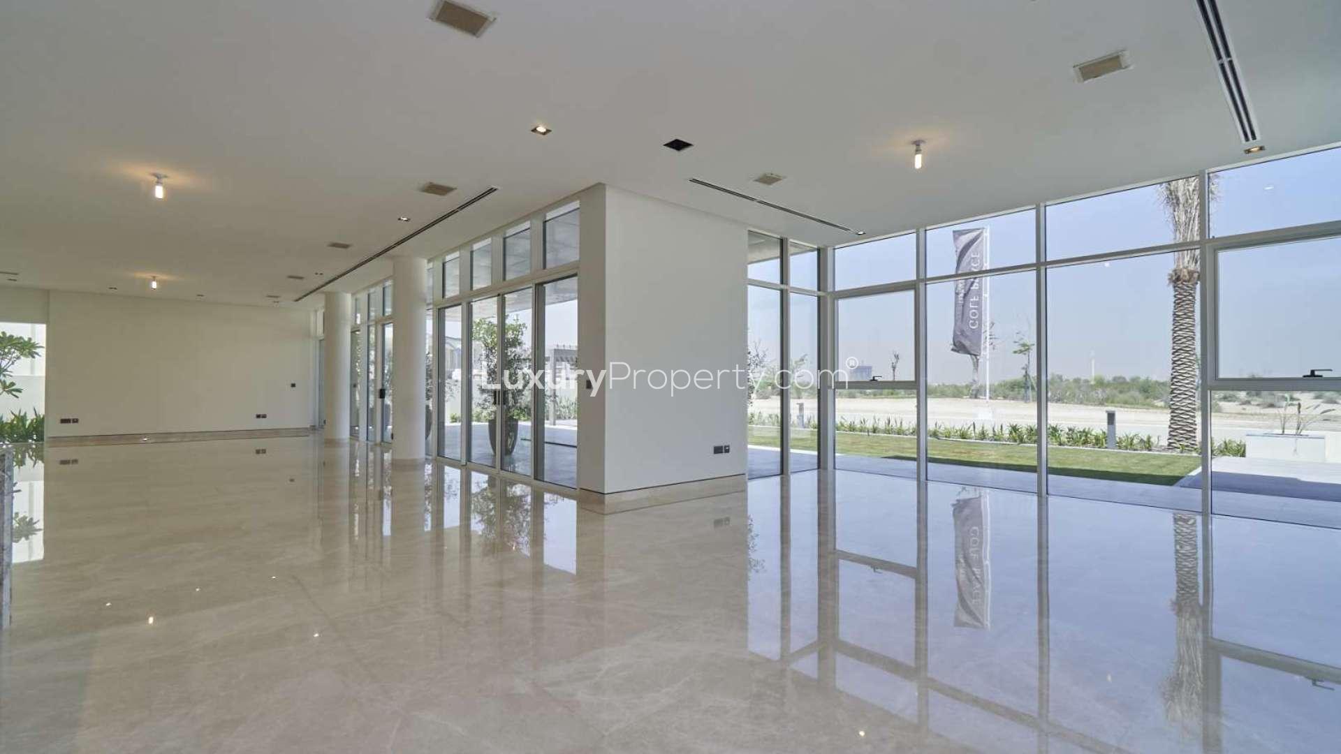 Modern villa exterior at Golf Place, Dubai Hills Estate, showcasing large windows and landscaped garden