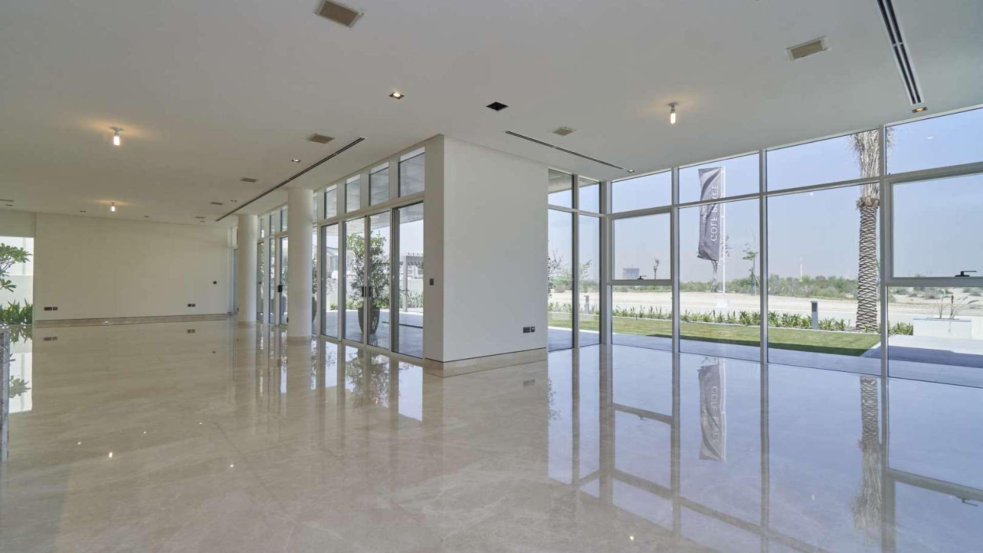 Modern villa exterior at Golf Place, Dubai Hills Estate, showcasing large windows and landscaped garden