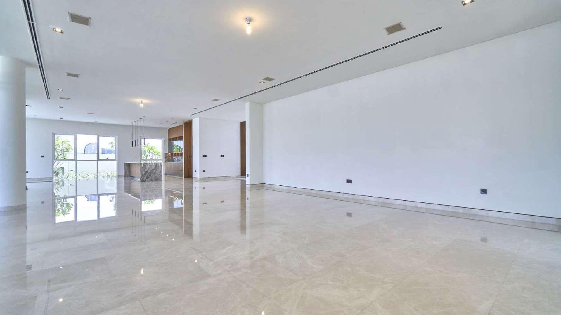 Spacious interior of Golf Place villa, Dubai Hills Estate, with large windows and marble floors