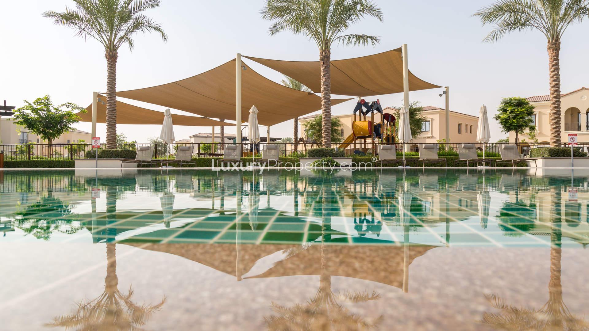 Charming Lila Villas entrance with palm trees, Arabian Ranches 2, Dubai. For sale