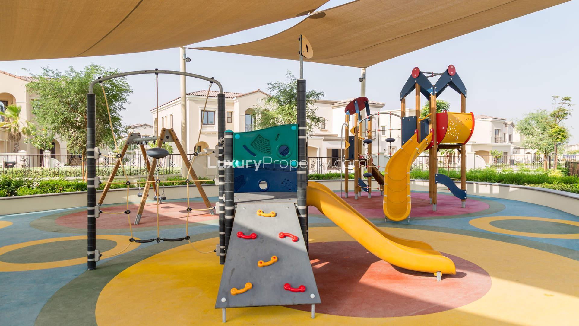 Outdoor pool and playground at Lila Villas, Arabian Ranches 2, luxury residential community