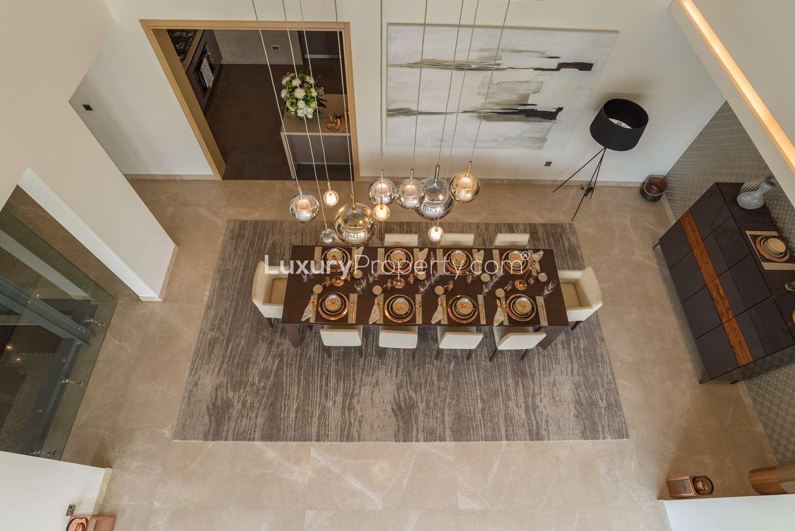 "Luxurious villa with modern pool at Sobha Hartland, MBR City, for sale.",Luxurious dining area in Sobha Hartland villa at MBR City, elegant modern design